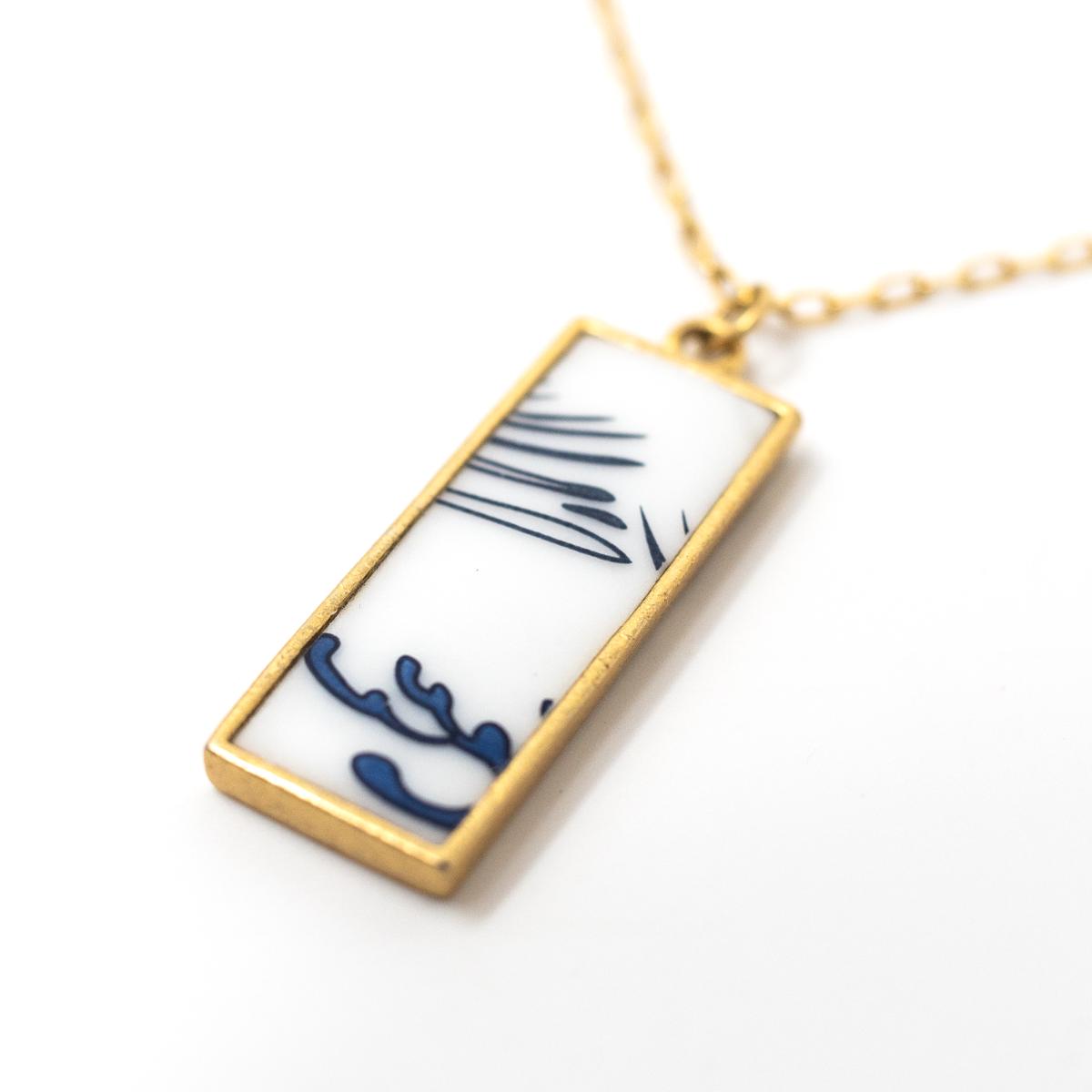 nozomi gold necklace tall blue white angle
