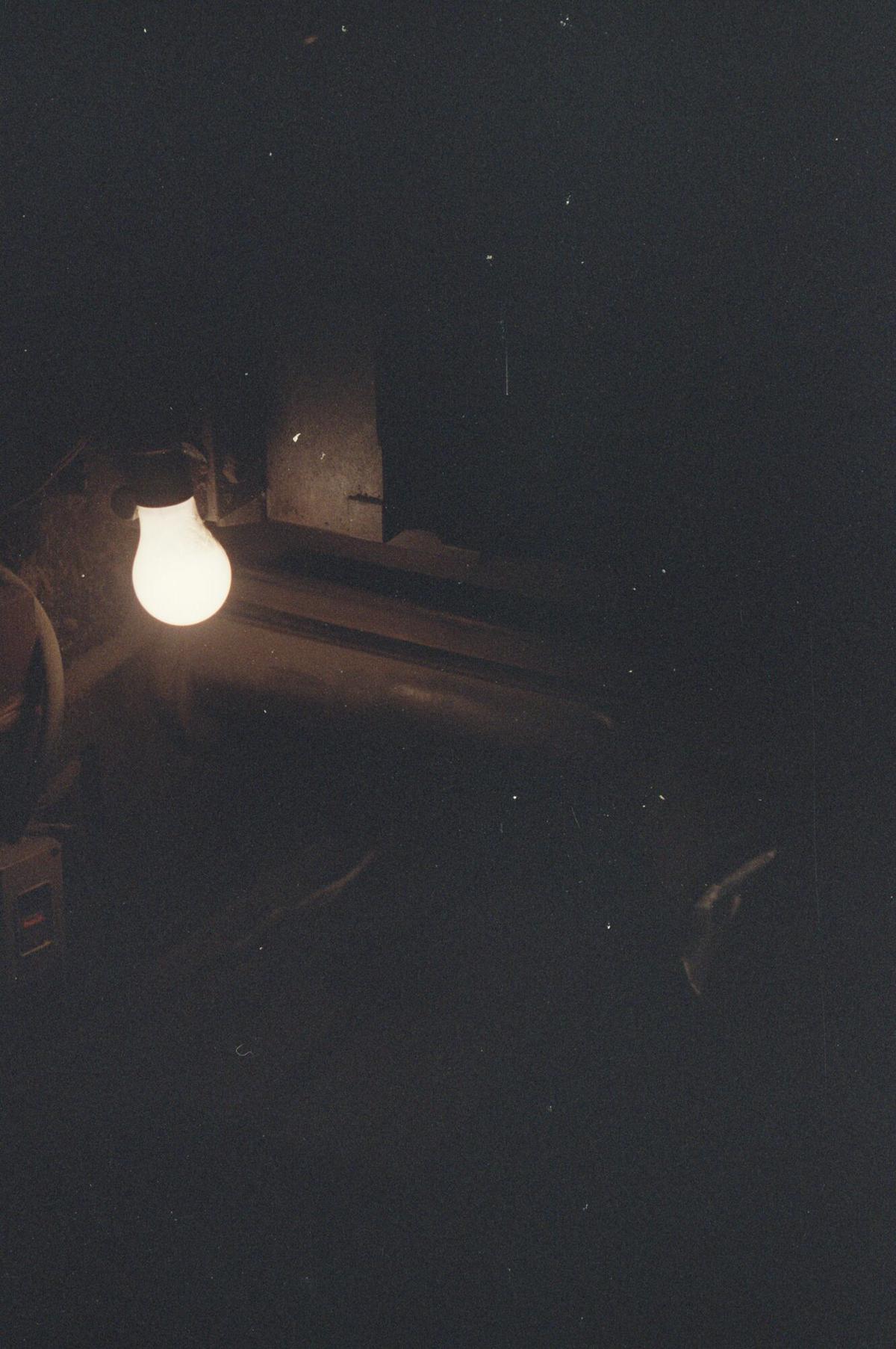 Glowing charcoal in the darkened Negishi workshop