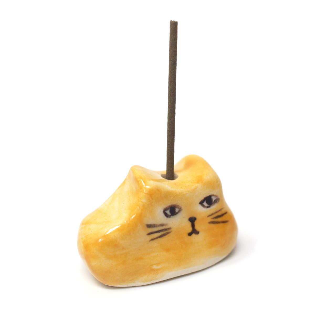 Mustard yellow ceramic cat incense holder with an incense stick