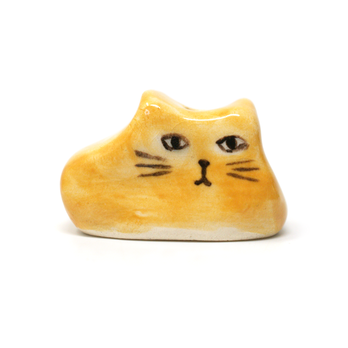 Mustard yellow ceramic cat incense holder from the front