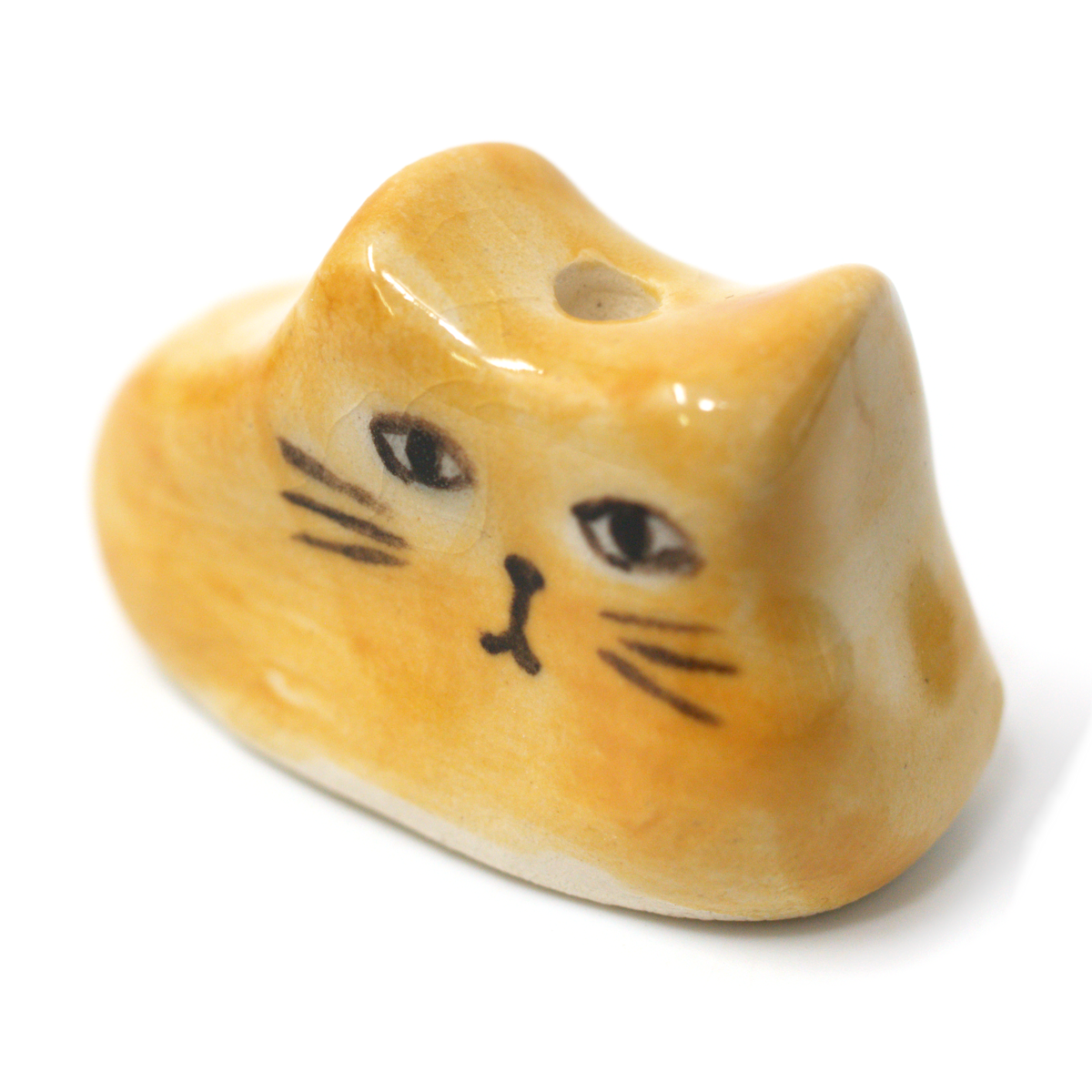 Mustard yellow ceramic cat incense holder at an angle